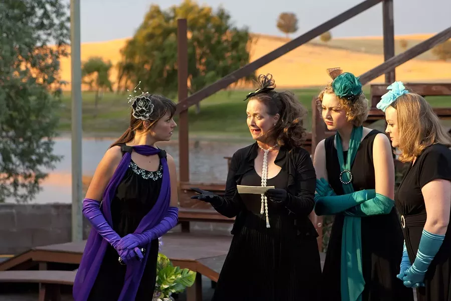 WHAT TIDINGS?: The princess of France (Heather MacLeod-Schultz, far left), eagerly listens to a piece of news brought by her de facto messenger Boyet (Janet Stipicevich, letter in hand) while fellow ladies in waiting Rosaline (Claire Harlan, second from right) and Katharine (Angela Hutt-Chamberlin, far right) listen in. - PHOTO BY STEVE E. MILLER