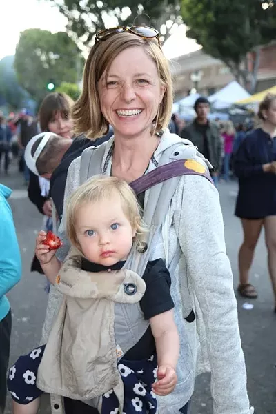 NATURE’S CANDY: Sarah Rignen and her happy baby get down on some fresh strawberries. - PHOTO BY DYLAN HONEA-BAUMANN