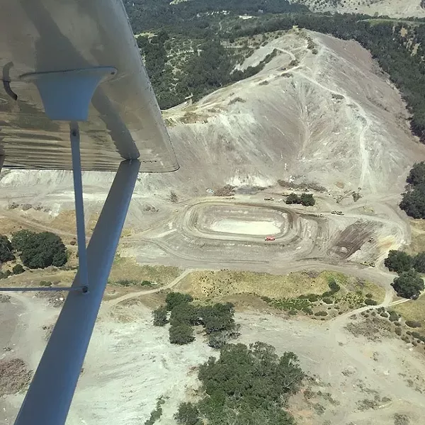 SO SORRY: This photo of a Justin Vineyards and Winery property was paired with a Google Earth image of the same view before acres of oaks, manzanitas, and madrones were cleared out, sparking widespread outrage. The company has since cancelled plans to continue additional tree clearance to make way for a 230-acre vineyard. - PHOTO COURTESY OF MATT TREVISAN
