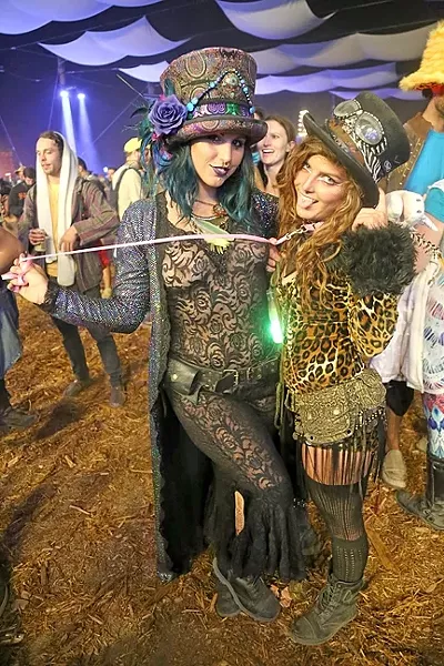 CELEBRATING SEXY: Zoe Elliott (right), held by her girlfriend Treanna Dearrillaga (left), says that she feels sexy to be seen by others and hopes people get a kick out of it. “We just like to add to the experience and just be fucking weirdoes at a festival,” Dearrillaga said. - PHOTO BY DYLAN HONEA-BAUMANN