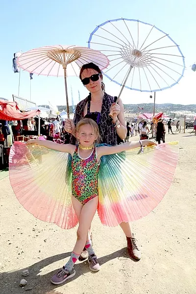 FAMILY BONDING : Marina Panda stands with her 7-year-old daughter Margarita, who’s been to three such festivals in her short life. - PHOTO BY DYLAN HONEA-BAUMANN