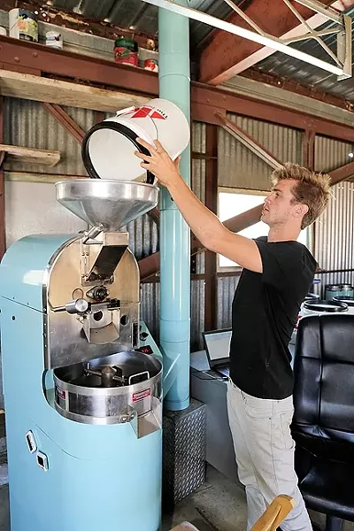 A NEW PARADIGM: Paradigm Coffee co-founder and Roastmaster Reid Patterson roasts site-specific beans from Costa Rica with a state-of-the-art roaster he purchased from friend and fellow specialty coffee nerd Jonathan Strauf, owner of downtown coffee hub Bello Mundo. - PHOTO BY DYLAN HONNEA-BAUMANN