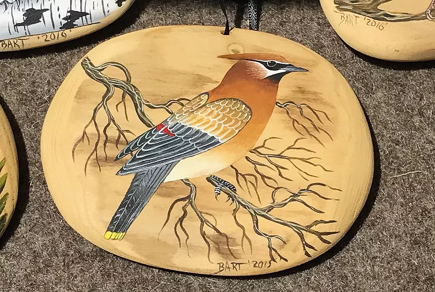 DRIFTING AWAY Dennis "Bart" Theiler paints birds and other animals on driftwood.