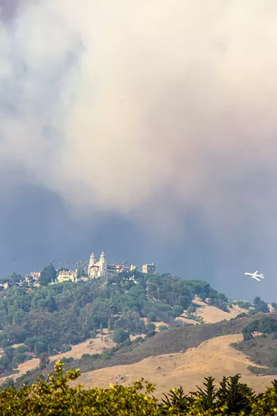 SAVE THE CASTLE An air tanker drops fire retardant near Hearst Castle as the Chimney Fire came within 2 miles of the national landmark. The castle shut down to public tours for several days. - FILE PHOTO BY JAYSON MELLOM