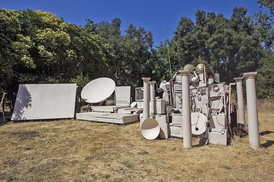 ROAD LESS TRAVELED Twenty-something artist and musician Dr. Isapony XD built what he calls his "time machine"—all sourced from discarded electronics and building materials—in the backyard of his Atascadero rental, where he screens movies and hosts concerts. - PHOTO BY JAYSON MELLOM