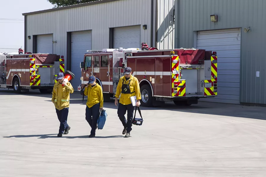 TRAINING DAY Paso Fire Department's John Prickett, Amanda Donovan, and Robby Smith (left to right) participate in a training exercise with Cal Fire on Aug. 18. - PHOTO BY JAYSON MELLOM