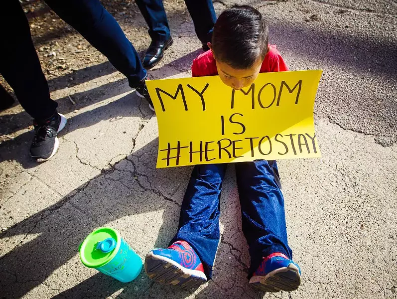 RALLYING FOR DREAMERS SLO residents gathered Sept. 5 to show their support for undocumented immigrants brought to America as children and the federal DACA program, which may come to an end in six months. - PHOTO BY JAYSON MELLOM