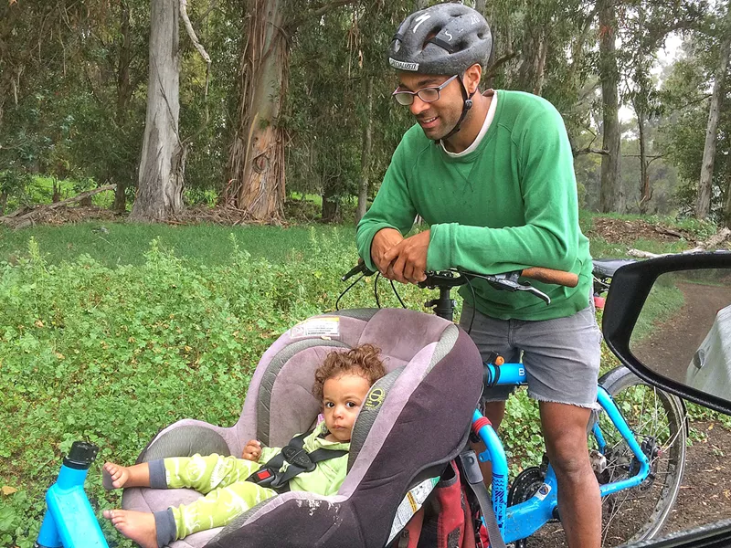 GINGER MAN Michael Huggins and baby daughter Cedar Huggins-Denbow take a spin around Dacite Farm in SLO. Two years ago, the farm received guidance and local funding via local nonprofit Slow Money SLO, allowing Huggins to erect a greenhouse and supply certified organic turmeric, ginger, and tomatoes to local folks. - PHOTOS COURTESY OF SLOW MONEY SLO