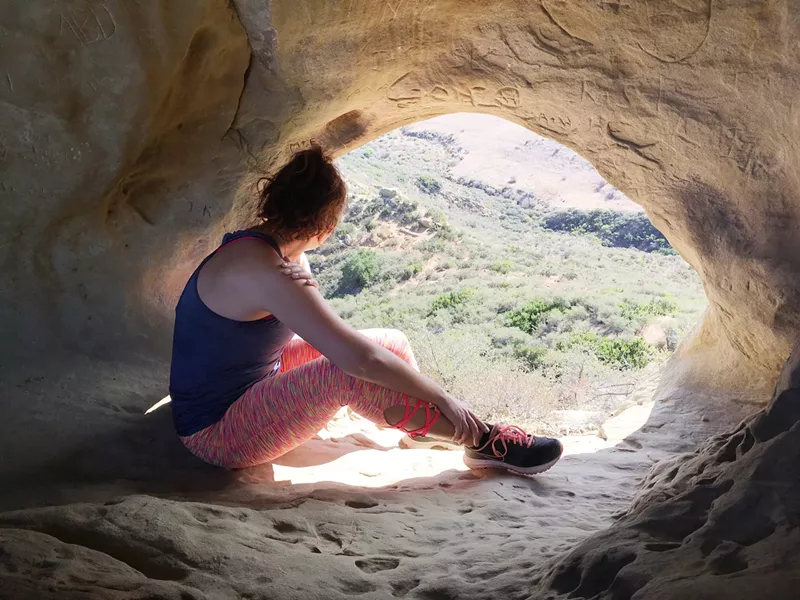 CONTEMPLATE The most adult moment of the whole hike is a few seconds of reflection out this portal to the Pacific Coast. - PHOTO BY LEANNA GARBI