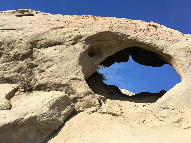 HOLEY ROCK This is one cave of several to explore if you clamber up to the Gaviota Wind Caves near Gaviota State Park in Santa Barbara County. - PHOTO BY CAMILLIA LANHAM