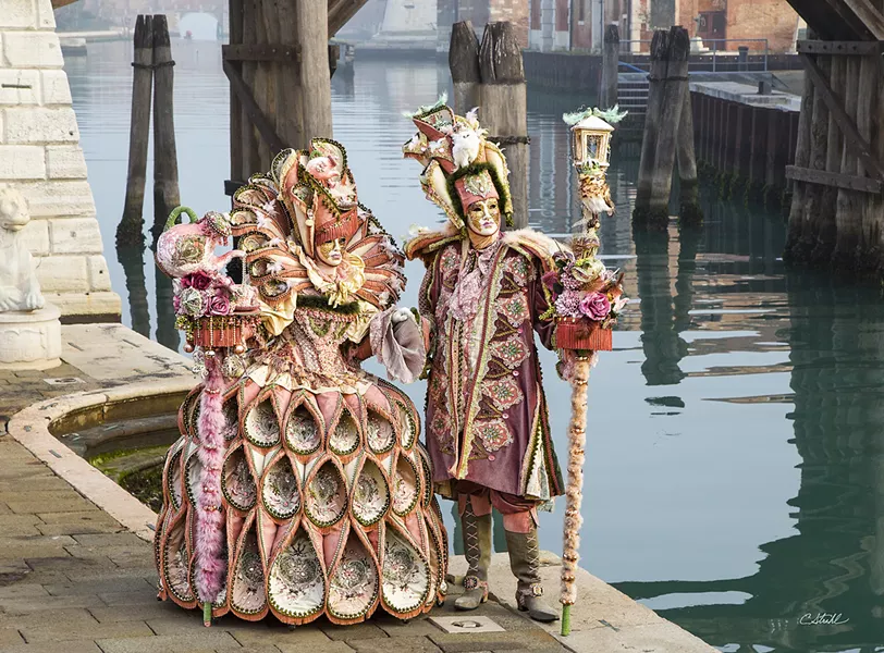 DETAILS From the teapot on top of the lady's staff to the birdhouse on top of the gentleman's there are endless details to pick out in Cheryl Strahl's delightful photo of this pink-clad Carnevale couple. - PHOTO COURTESY OF CHERYL STRAHL