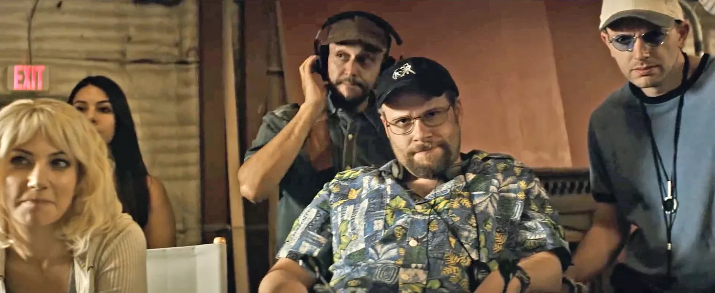 TAKE 37! Juliette (Ari Graynor, far left), Sandy (Seth Rogen, center foreground), and Raphael (Paul Scheer, far right) look on in consternation as Tommy (off screen) repeatedly flubs his line. - PHOTO COURTESY OF NEW LINE CINEMA