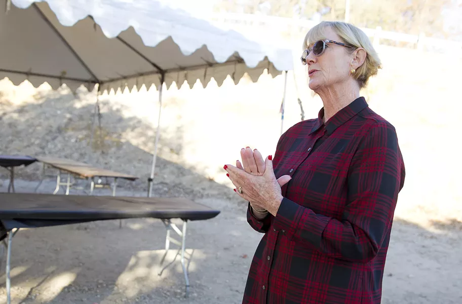 HELPING HAND Gail Oliver, a volunteer with nonprofit Paso Cares, shows New Times where it hosts the People's Kitchen in Paso Robles: a municipal parking lot. - PHOTO BY JAYSON MELLOM