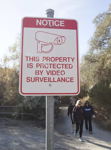 ON CAMERA A sign on the Paso Robles River Walk trail warns of surveillance cameras. - PHOTO BY JAYSON MELLOM