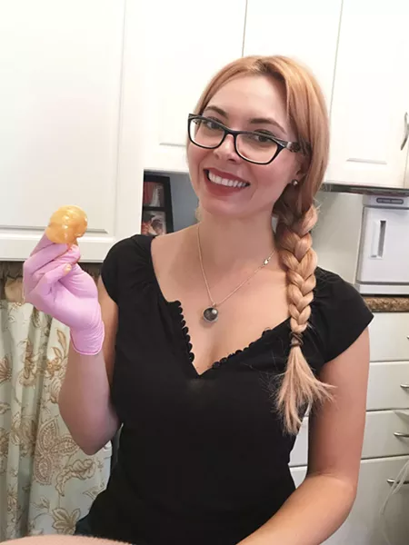 POUR A LITTLE SUGAR ON ME Masha Schroeder, of The Skin Boutique in SLO, holds a ball of sugar paste that is used to remove body hair in lieu of hot, painful wax. - PHOTO COURTESY OF THE SKIN BOUTIQUE