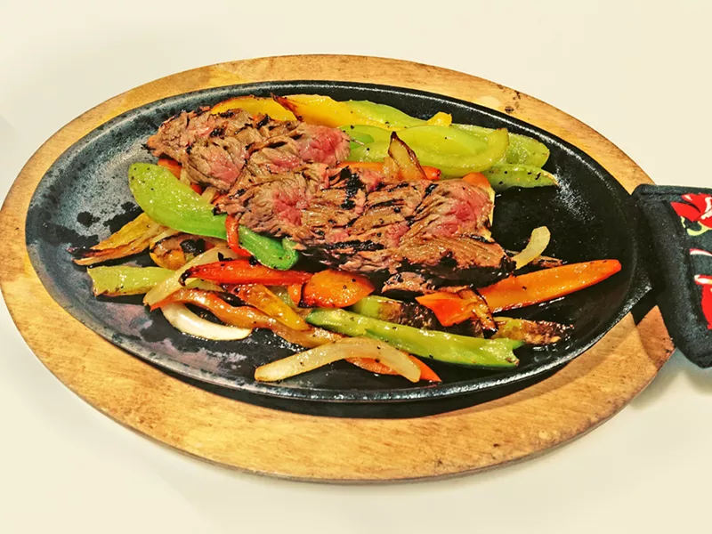 ORDER UP At La Esquina, beef is always aged in-house for three months and cooked to order. That means you can order these flavorful fajitas bloody, pink in the middle, or charred all over. - PHOTO COURTESY OF LA ESQUINA