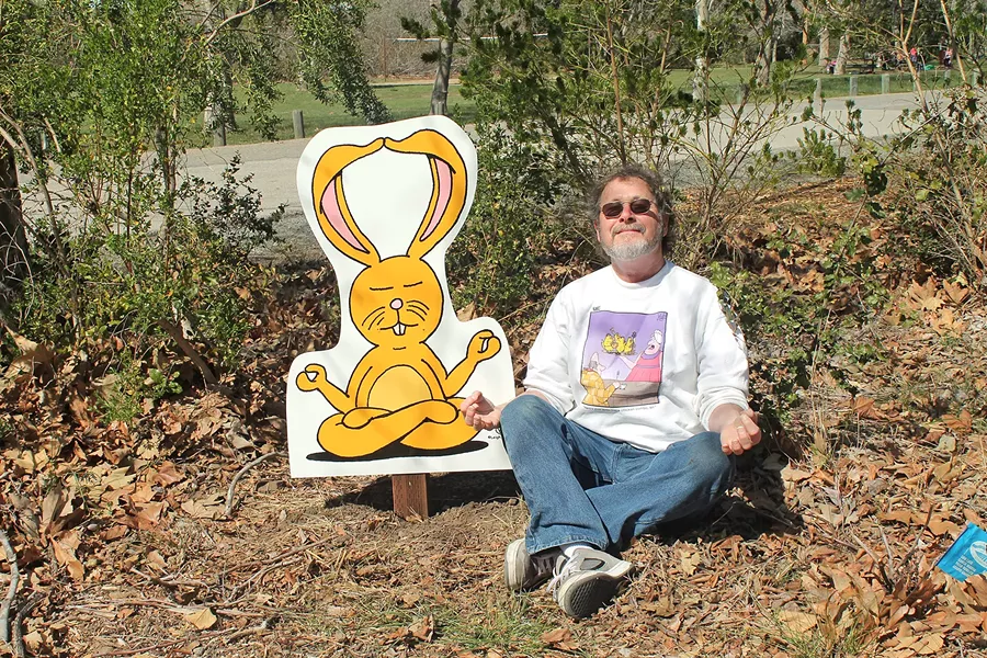 ZEN Cartoonist Leigh Rubin relaxes with his creation Lounging Bunny at the SLO Botanical Garden. - PHOTO COURTESY OF LEIGH RUBIN