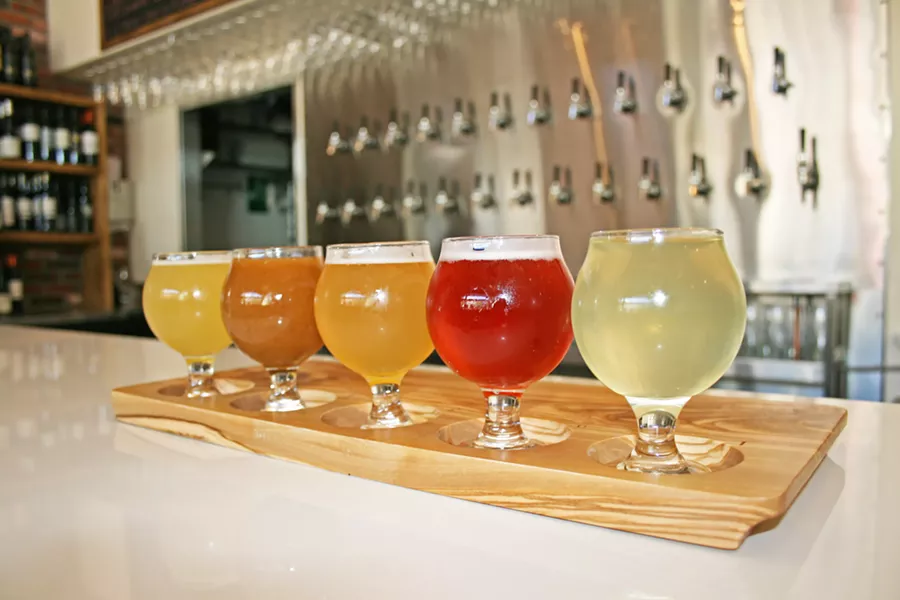 FRESH PICKED Sip a colorful, crisp tasting flight of unique fruit ciders at Cider Bar, located within the revamped Creamery in SLO. From left to right, Farmhouse kiwi, strawberry, white peach, pluot, and Asian pear, all fermented by Cider Bar owner Kevin Mclaughlin. - PHOTO BY HAYLEY THOMAS CAIN