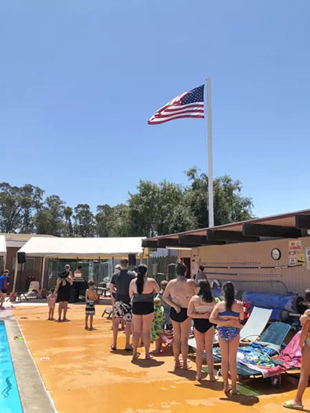 ALLEGIANCE Elks members and their guests stand and place hands over hearts for "The Star-Spangled Banner," on Memorial Day, May 31. - PHOTO BY GLEN STARKEY
