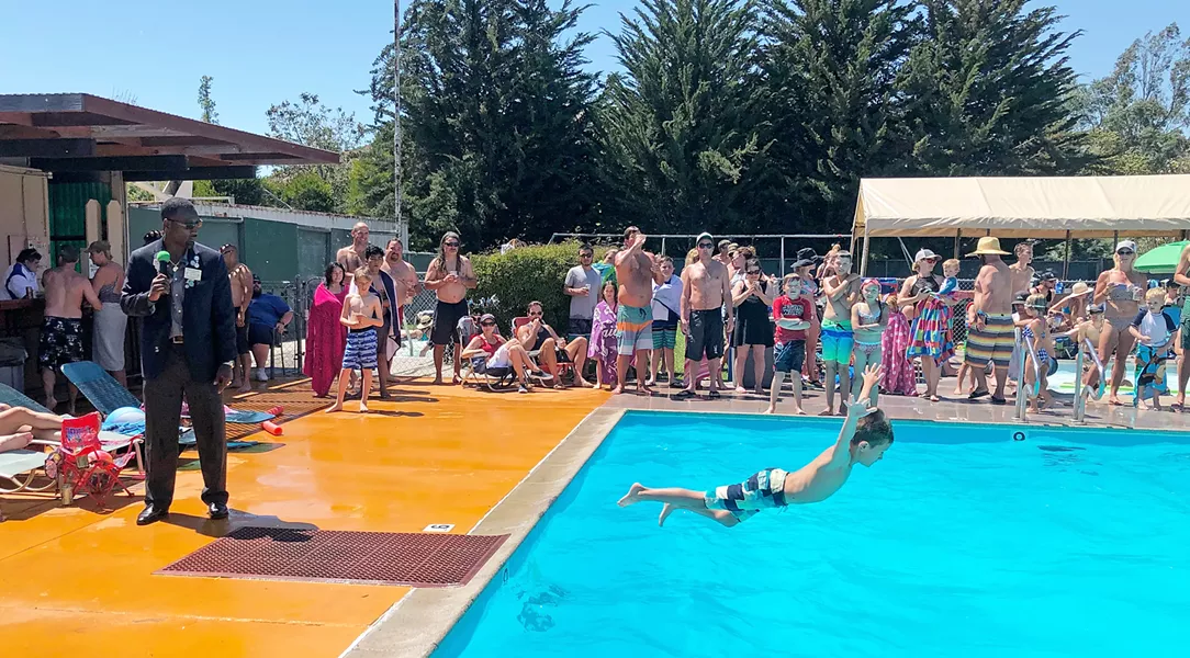 TOP FLOPPER Kids compete for the best belly flop, with the crowd applause-o-meter deciding the winner. - PHOTO BY GLEN STARKEY