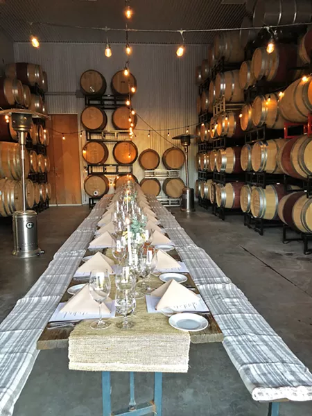 ALL THIS CAME FROM A TRUCK? The Truck's first event showed just what a mobile catering service can do. The five-course, sit-down dinner served at Clos Solène winery in Paso Robles featured a rustic barn, fine linens, and table service. - PHOTO COURTESY OF CAROLE MACDONAL