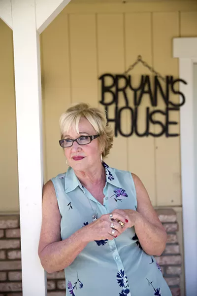 FINDING MEANING Sandy Wortley stands in front of Bryan's House, a residential treatment facility for women struggling with substance abuse. Wortley runs the home that she named after her son, Bryan, who died in 2010 after struggling with an opioid addiction. - PHOTO BY JAYSON MELLOM
