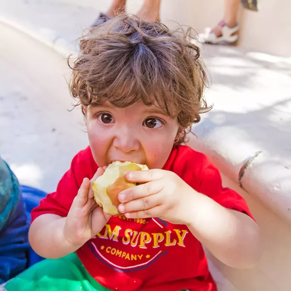 SUMMER MEALS Although 2-year-old Waylon Watkins is not enrolled in any financial assistance programs, his mother Brianne Watkins is grateful for the option of a meal or snack when attending the San Luis Obispo County Library. - PHOTO BY JAYSON MELLOM