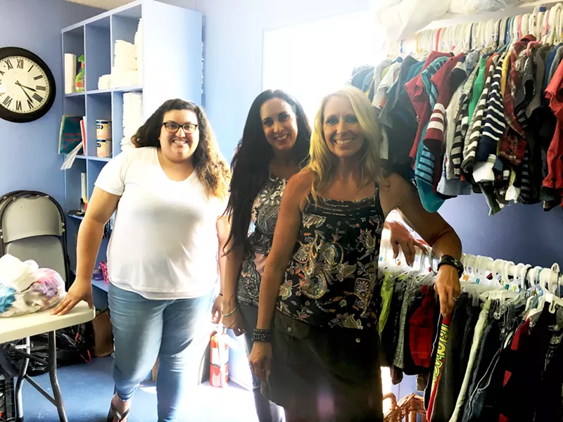 IT TAKES A TRIBE Owner Lisa Ray (middle) attributes the success of the Children's Resource Network to her team of volunteers, program directors Nisa Solis (left) and Lori Klemowicz (right), and mothers who spread the word. - PHOTO BY KAREN GARCIA