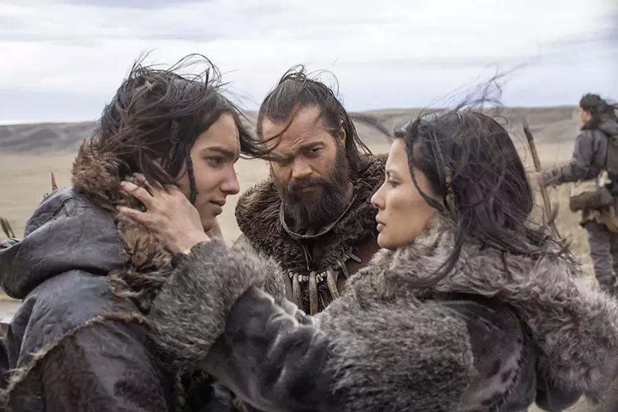 CLAN LIFE Keda (Kodi Smit-McPhee, left) is bid goodbye by his mother, Rho (Natassia Malthe, right), as he leaves on his first hunt with his father, Tau (Jóhannes Haukur Jóhannesson, center). - PHOTO COURTESY OF STUDIO 8