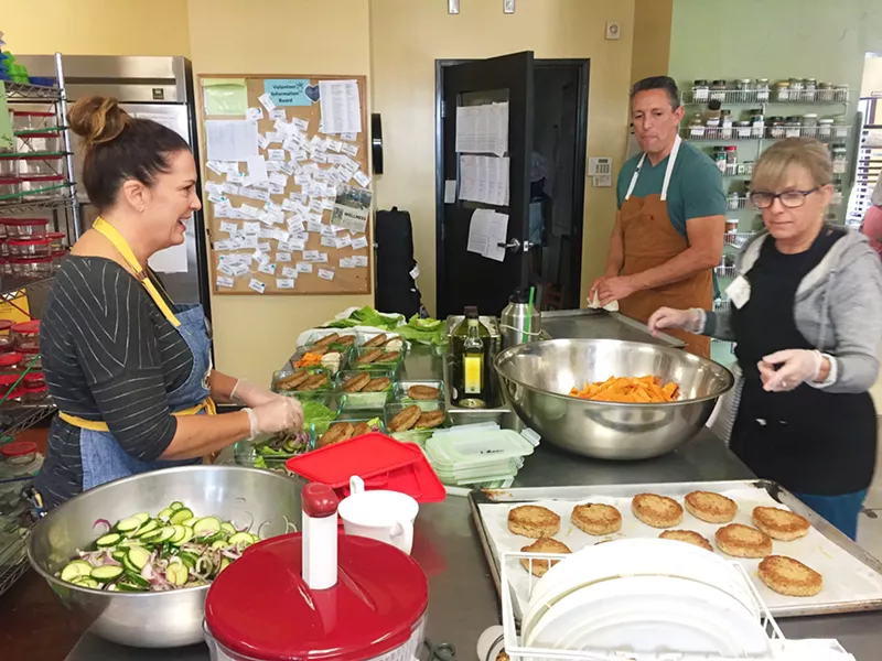 HEALING THROUGH THE KITCHEN Volunteers work daily at The Wellness Kitchen and Resource Center to learn about and prepare healthy foods. - PHOTO COURTESY OF THE WELLNESS KITCHEN AND RESOURCE CENTER