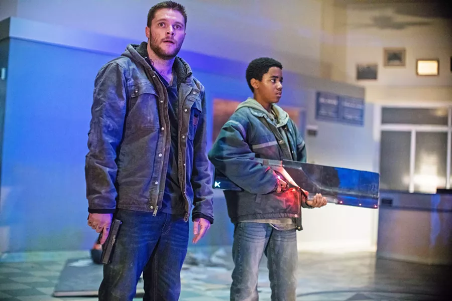 BROTHERS Ex-con Jimmy (Jack Reynor, left) and his adopted brother Eli (Myles Truitt) must protect themselves from criminals, federal agents, and alien soldiers who are after a weapon Eli found, in the sci-fi actioner Kin. - PHOTO COURTESY OF LIONSGATE
