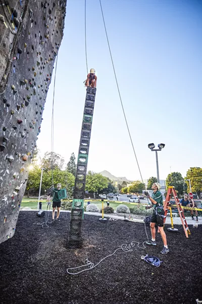 CONQUER THE STACK Cal Poly students compete in a crate stacking competition at the outdoor climbing park hosted by Poly Escapes. - PHOTO BY IAN PEARMAN, COURTESY OF ASI