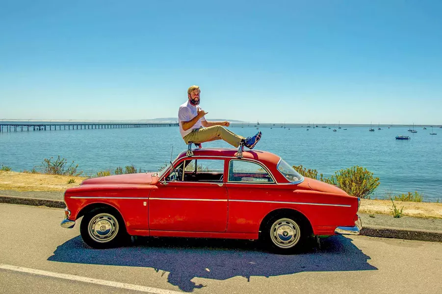 GIVING BACK IN STYLE Ryan Burmaster is president and co-founder of SloRolling, a vintage Volvo group that works on cars and gives back to the community. - PHOTO COURTESY OF SLOROLLING