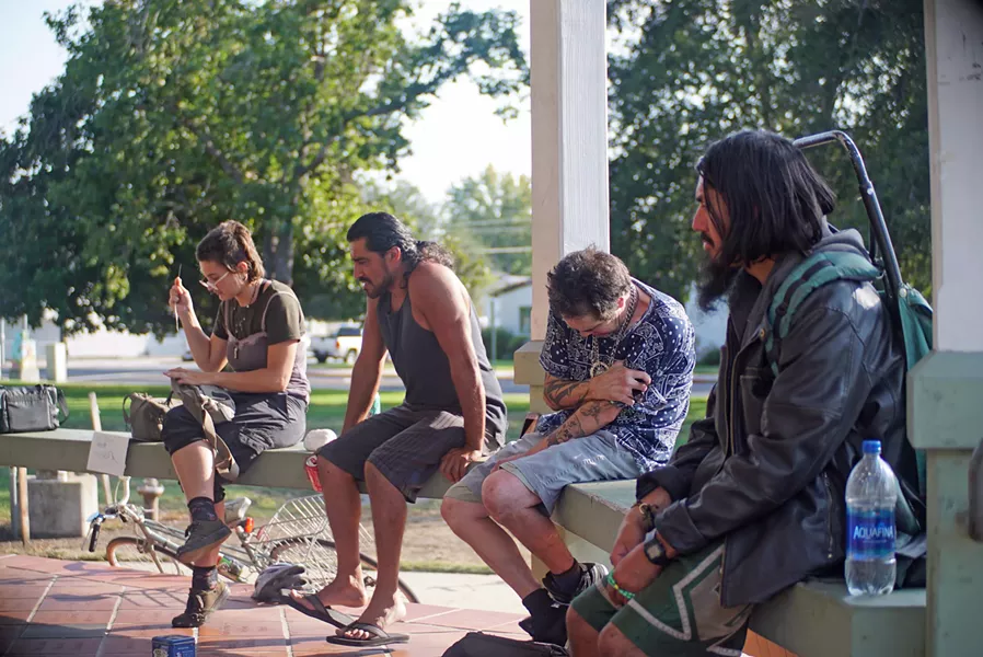 GATHERING Members of SLO's homeless community and others gather at Mitchell Park, where the local chapter of Food Not Bombs offers a meal once a week. - PHOTO COURTESY OF FOOD NOT BOMBS SLO