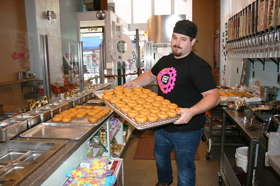 DOLLARS TO DOUGHNUTS You've got to wake up pretty early to beat Downtown Donut Company owner Josh Morrow to work. He's always up bright and early with "doughnut chemist" Sam Lopez, churning out dozens of moist cake donuts, which serve as blank canvases for the day's DIY doughnut creations. - PHOTO BY HAYLEY THOMAS CAIN