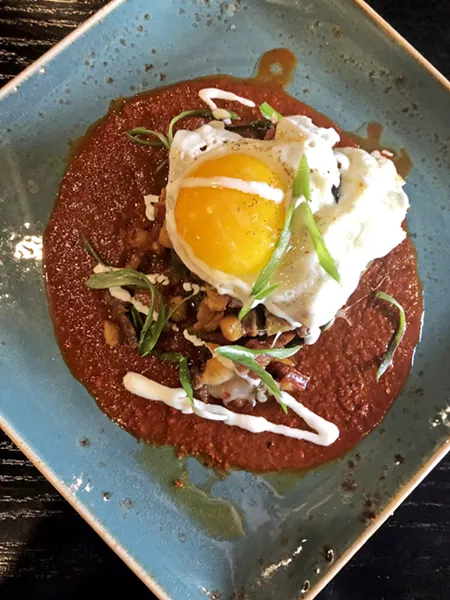 SUNNY SIDE Leroy's stuffed chile relleno is filled with tri-tip, bacon, and linguiça from Cattaneo Brothers, guajillo chili sauce, queso fresco, crema, and topped with a sunny-side-up egg. - PHOTO BY HAYLEY THOMAS CAIN