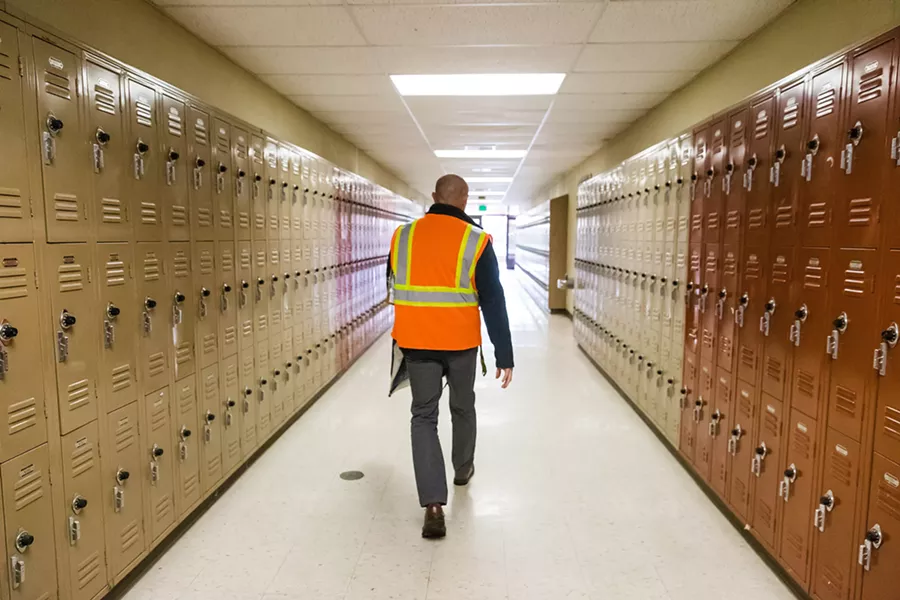 PATROLLING FOR SAFETY SLO High School Principal Leslie O'Connor walks the halls of campus during a lockdown drill in January to ensure that teachers and students are following protocol. - PHOTOS BY JAYSON MELLOM
