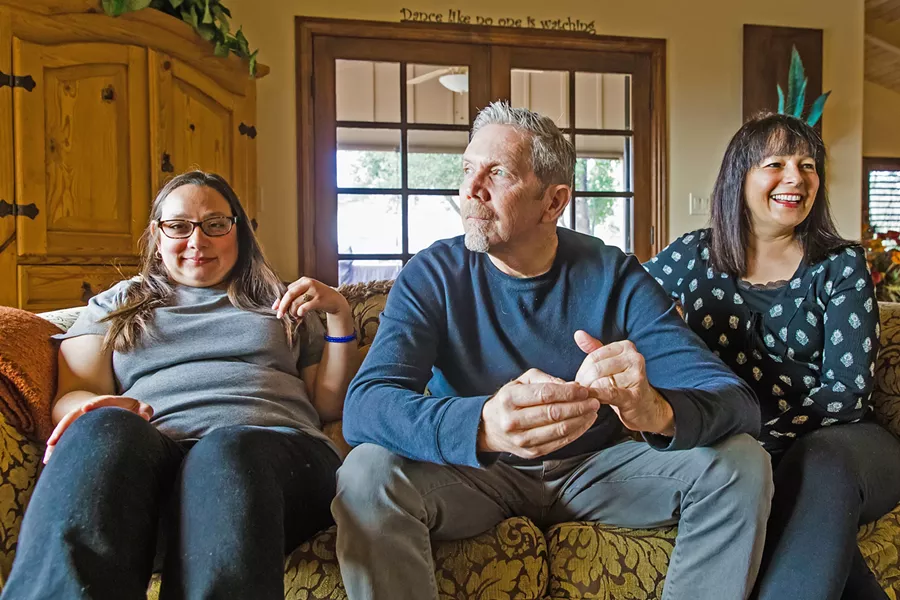 FAMILY SOLIDARITY Heather, Tim, and Nitzi Joannes (left to right) had a disturbing experience with subminimum wage employment in 2015, when Heather, who has a cognitive disability, was paid less than minimum wage at a business that was unpermitted to do so. Their ordeal led to a lawsuit and federal investigation into the wage practices at Paso Robles' NCI Affiliates. - PHOTO BY JAYSON MELLOM