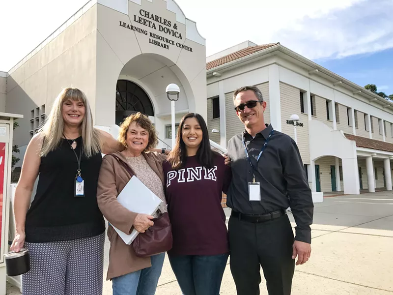 CHASING DREAMS Third-year Cal Poly student Ashley Romero (center right), 23, who has cerebral palsy, is helping adults with disabilities find their paths as an instructional aide at Cuesta College. Here, she's posing with Joey Carroll, a Tri-Counties Regional Center employment coordinator; Carol Lopes, a Cuesta College instructor; and Jeffrey Waggoner, a PathPoint employment specialist (left to right). - PHOTO BY PETER JOHNSON