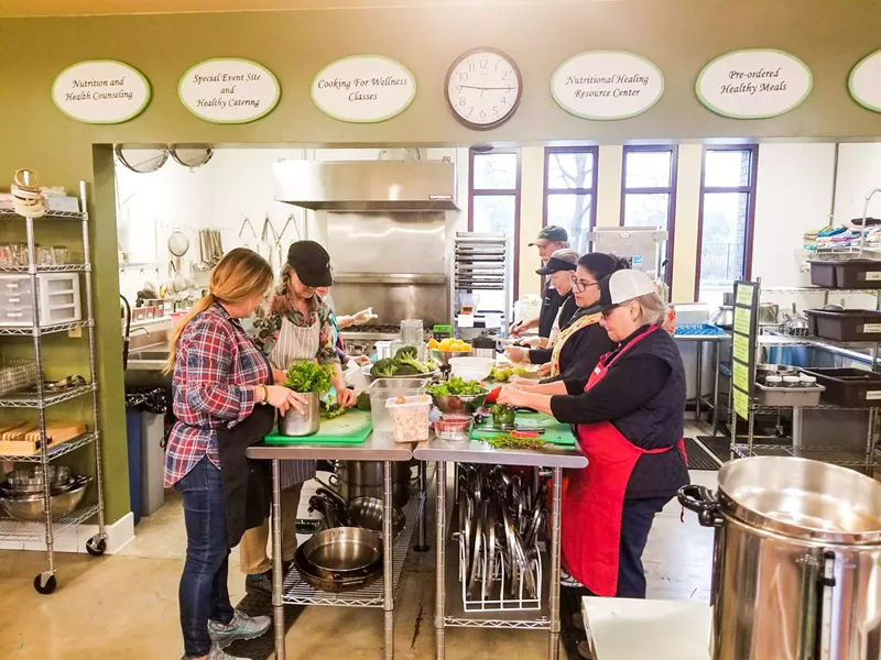 COOK IT UP Volunteers prep food in Templeton again after spending three months using the Atascadero Bible Church's kitchen to keep the nonprofit delivering food to its members. - PHOTO COURTESY OF THE WELLNESS KITCHEN