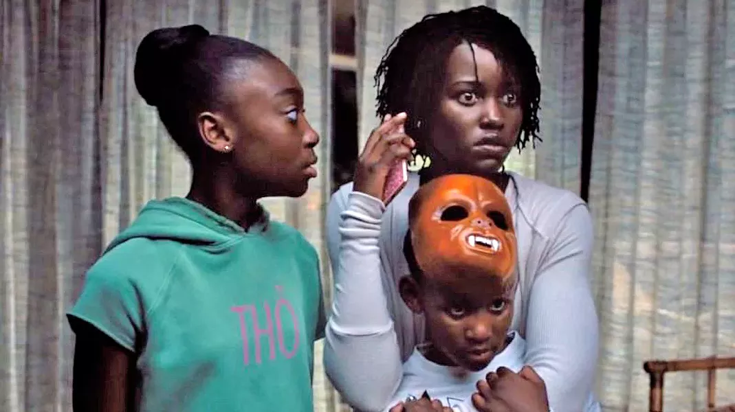TERRORIZED A family—including mother Adelaide (Lupita Nyong'o right), daughter Zora (Shahadi Wright Joseph, left), and son Jason (Evan Alex, bottom right)—is threatened by evil doppelgängers, in Us. - PHOTO COURTESY OF MONKEYPAW PRODUCTIONS