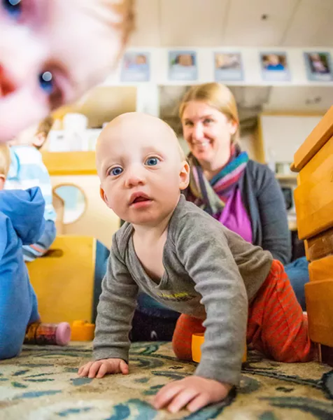 CARE WANTED Nova, who attends the Cal Poly ASI Children's Center, appears intrigued by New Times photographer Jaysom Mellom. Infant care is an often unmet and rapidly growing need in SLO County. - PHOTOS BY JAYSON MELLOM
