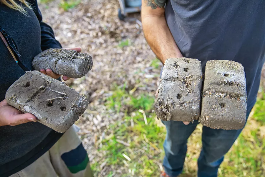 TESTING, TESTING Cobber's often work with materials found on-site to craft the compound that will eventually build the structure. These bricks are one way of testing the composite for strength. Each is made up with different ratios of soil, sand, and straw. - PHOTO BY JAYSON MELLOM