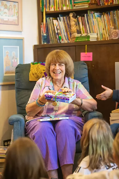 ALL YOU CAN READ Liz Krieger and her band of volunteers host a book party every spring where an elementary school class can come and take as many books as they can carry home with them. - PHOTOS BY JAYSON MELLOM