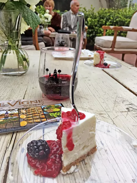MAY I HAVE ANOTHER? There's just something about eating this little morsel of cheesecake covered in berry goodness while I'm seated in the courtyard of one of Hearst Castle's guest houses. - PHOTOS BY CAMILLIA LANHAM