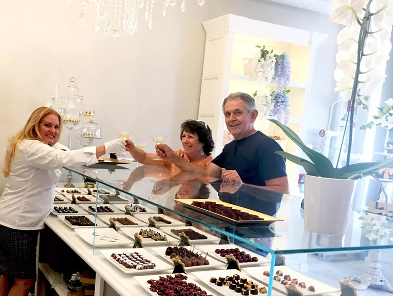 LIVING IT UP Locals Andrea and Randy Chavez decide to stop by Sheila Kearns Chocolate & Confections after a downtown matinee, on their way to the bookstore. Andrea is a big fan of Sheila's Cabernet Sea Salt Caramels, and Randy likes to try all the gluten-free bites. - PHOTO BY BETH GIUFFRE