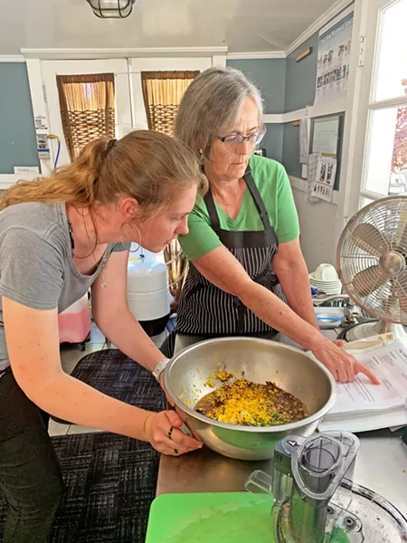 OFFICE MANAGER EXTRAORDINAIRE Office Manager Terri Knowlton (right)makes fig chutney with intern Maggie. Knowlton is in charge of Fig's community outreach, networking, program and event coordinating, and more. She's known at Fig as the person who connects the dots to make it all happen. - PHOTO COURTESY OF CHRISTINA DILLOW