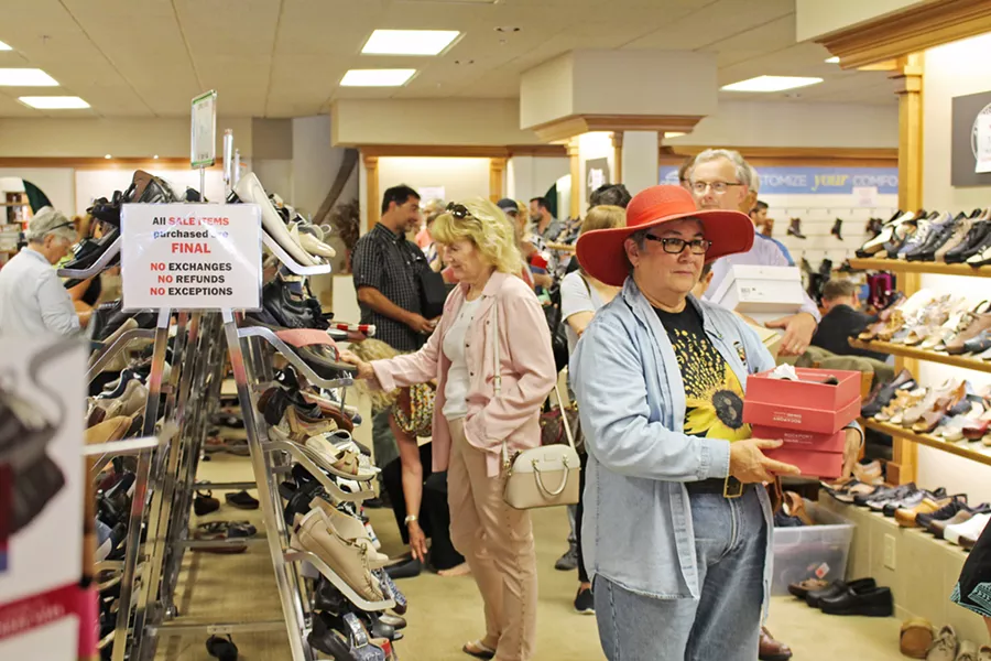 A PIVOTAL STORE LOST Customers take advantage of huge closing sales at Charles Shoes on Aug. 15. The store closed this summer after more than 50 years in business. - PHOTO BY KASEY BUBNASH