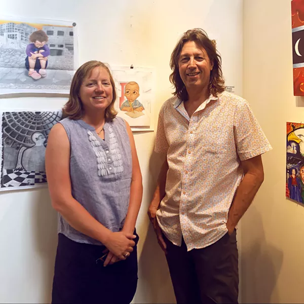 ART FROM THE SOURCE Justice in Justice curators Heather and Kevin Mikelonis stand with a favorite piece of theirs by artist Hugo Gonzalez. Gonzalez's work was discovered through Barrios Unidos, an organization dedicated to providing re-entry opportunities to former prisoners. - PHOTOS BY MALEA MARTIN