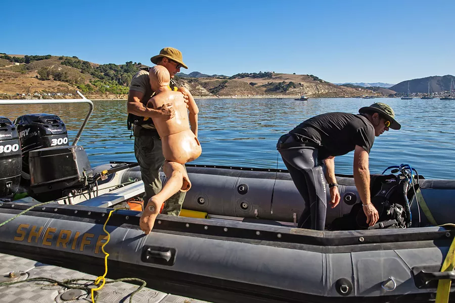 LOCATE THE VICTIM SLO Sheriff's Deputy John McKenney brings a dummy victim onto the department's boat for a dive team training exercise. - PHOTO BY JAYSON MELLOM